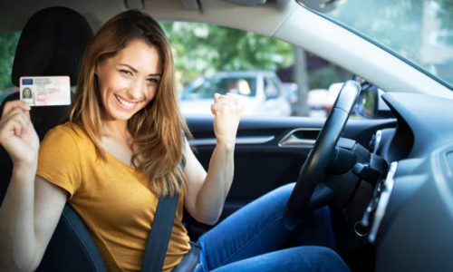 Sumit Car Driving 1 Car interior view of woman with driving license. Driving school. Young beautiful woman successfully passed driving school test. Female smiling and holding driver's license.